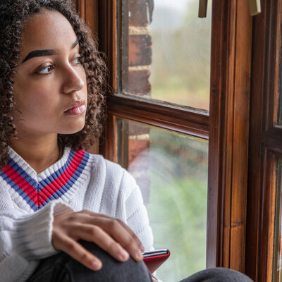 Teenager sitting calmly with tea supported by online teen hypnotherapy across Canada